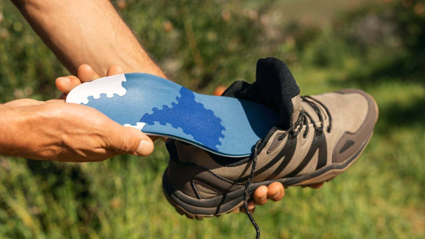 Bildausschnitt eines Wanderschuhs, der mit einer GloboTec Comfort Einlage versehen wird. Diese unterstützt die Füße beim Wandern und Nordic Walking.