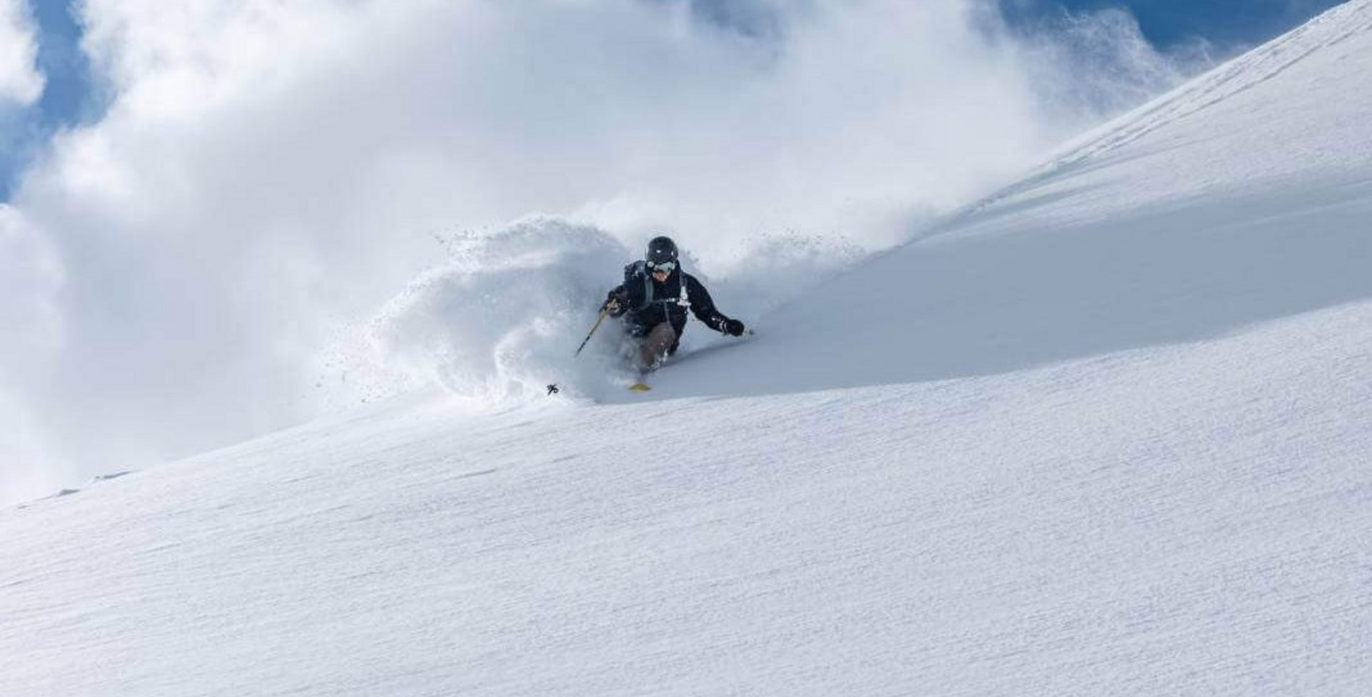 Abgebildet ist der Skifahrer Tom Klocker beim Fahren einer Kurve auf der Skipiste.
